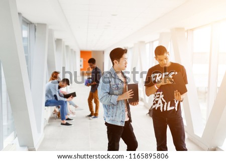 African-American and Asian student communicating in the University. The photo illustrates student life, education at University or College.