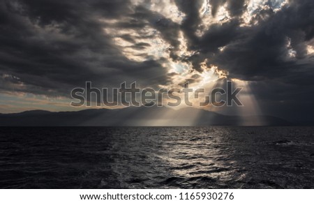 impressive clouds with sunrays over island of Peloponnese, Greece
