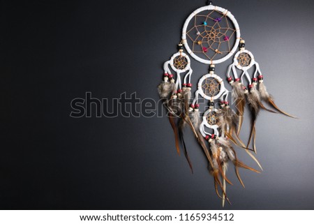 Dream catcher with feathers threads and beads rope hanging spiritual folk american native indian amulet isolated on black background.Copy space for text.Concept prevent evil in Halloween