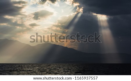 impressive clouds with sunrays over island of Peloponnese, Greece