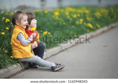 A little child on a spring day walk flower field

