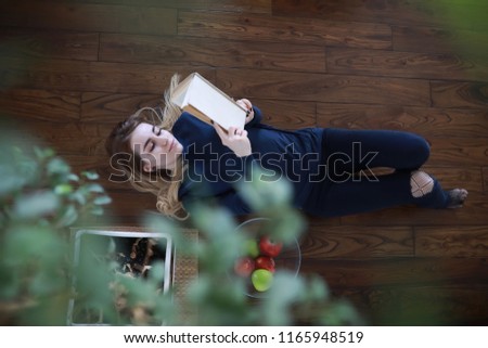 A young girl in a home setting is resting in a big apartment
