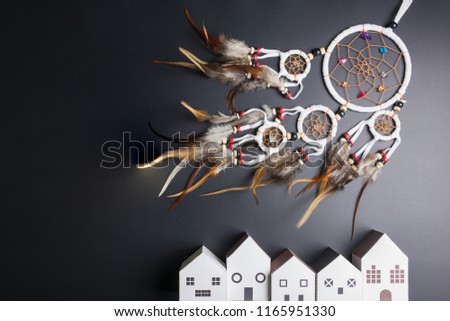 Dream catcher with feathers threads and beads rope hanging spiritual folk american native indian amulet and white home isolated on black background.Concept prevent evil in Halloween.