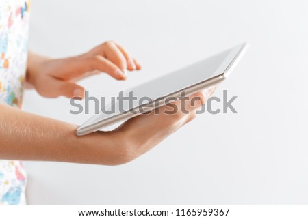 woman holding digital tablet, closeup