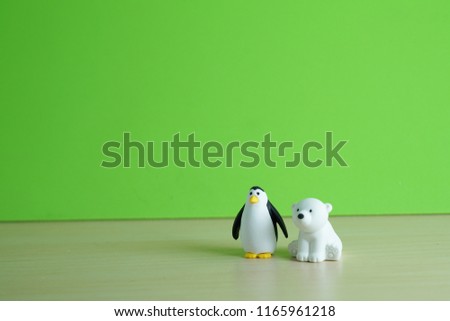 Polar bear and penguin rubber toy act as friend. Cute background idea for friendship and family.