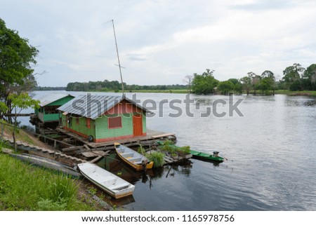 Houses along the Amazonas river. Brazilian wetland region. Navigable lagoon. South America landmark.