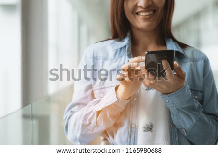 an asia woman using smartphone happy in town