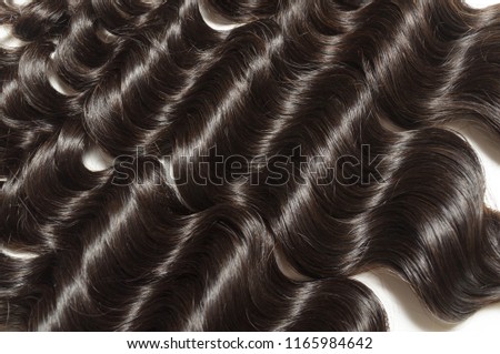Loose deep curly black human hair weaves extensions bundles Royalty-Free Stock Photo #1165984642