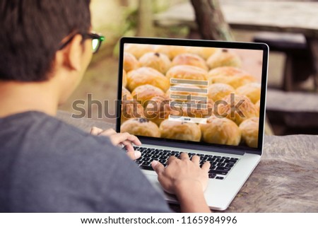 Man doing sign up username password log in protection concept on laptop / computer at the park / outdoor