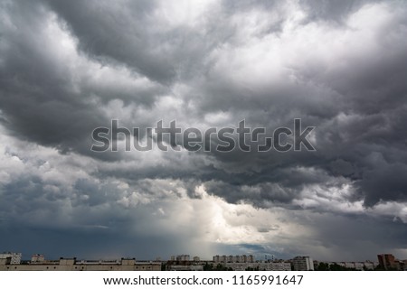 Dark dramatic sky with a stormy gray clouds just before storm - nature photography. The rain is coming soon. Pattern of the clouds over city. Heavy clouds but no rain. Royalty-Free Stock Photo #1165991647