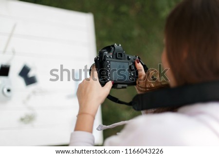 Woman professional photographer doing a photo shoot outdoors