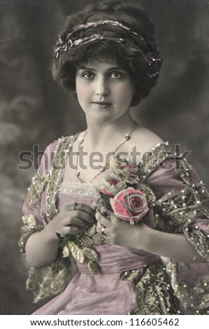 portrait of young beautiful woman with roses flowers. vintage picture from 1911