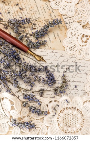 Vintage ink pen, dried lavender flowers and old love letters