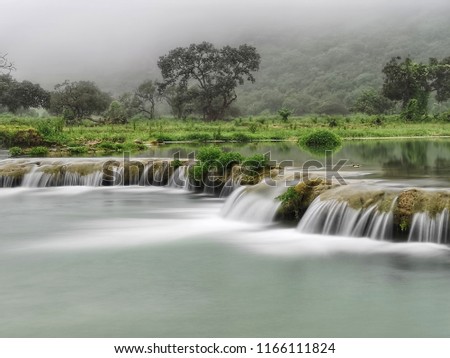Waadi Darbat flowing water Royalty-Free Stock Photo #1166111824