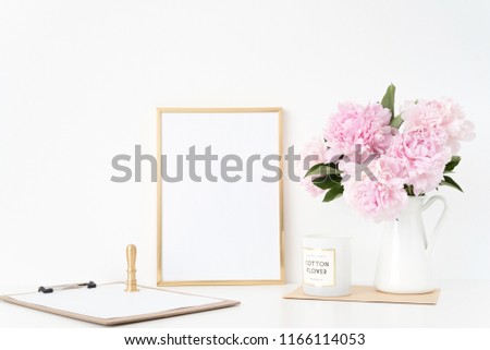 Modern gold portrait a4 frame mock up with a bouquet pink peonies in white jug, gold stamp. Overlay your quote, promotion, headline, or design, great for small businesses, lifestyle bloggers
