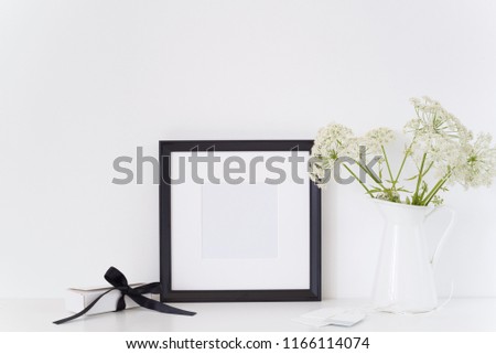 Black portrait square frame mock up with a Aegopodium podagraria in jug and present box. Mockup for quote, promotion, headline, design. Template for small businesses, lifestyle bloggers, social media