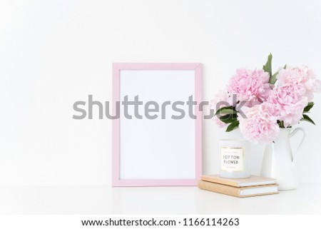 Cute pink portrait a4 frame mock up with a pink peonies in jug beside the frame, overlay your quote, promotion, headline, or design, great for small businesses, lifestyle bloggers and social media