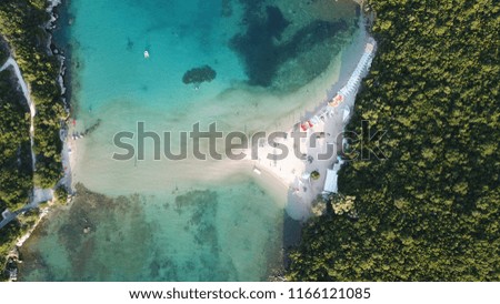 Aerial drone bird's eye view photo of tropical exotic bay with small islands and turquoise calm waters forming a blue lagoon