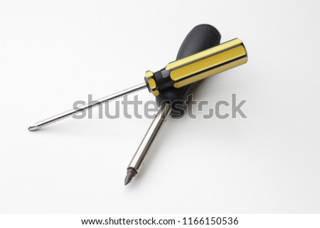 A screwdriver is a tool, manual or powered, for screwing and unscrewing screws. A typical simple screwdriver has a handle and a shaft. Royalty-Free Stock Photo #1166150536
