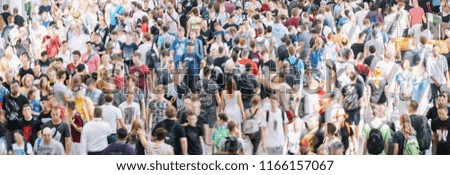 large crowd of  blurred people at a trade show