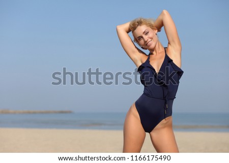 Young female enjoying sunny day on beach