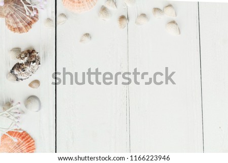 Vintage picture frame with sea shells on wood table top background