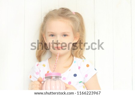 Beautiful girl drinking smoothie shake against white