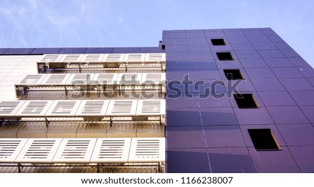 high white building in sunshine and shadows under blue sky