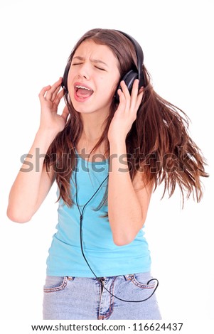 Nice teen girl listening to music with headphones