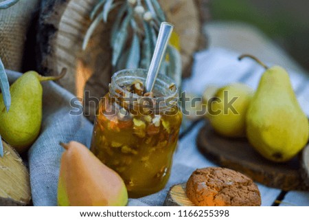 Autumn food photo. Honey with nuts on the table with biscuits and pears. Delicious nuts, honey, pears and cookies in rustic style autumn photo