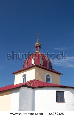 Roofs of ancient houses and domes of churches against the blue sky