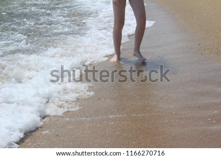 The boy is on a sandy beach in bright Sunny weather. Summer sea beach.