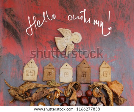 autumn background with autumn leaves ,chestnuts/figures of houses angels and birds/inscription "hello autumn"