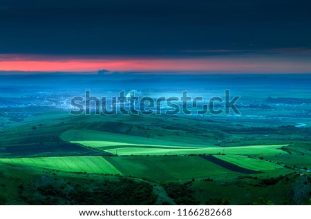 Before sunrise, after you wake up. Hiking for a quiet place outside the city before sunrise, Green landscape, fog and mist in the city. View from above. Space for text Royalty-Free Stock Photo #1166282668
