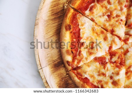 pizza margarita on wood dish in coffee shop background