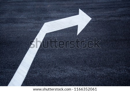 White arrow mark on the road