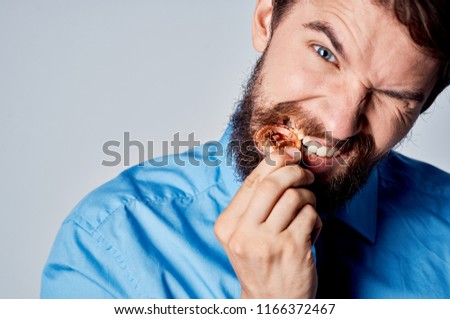 man bites coin Bitcoin                              Royalty-Free Stock Photo #1166372467