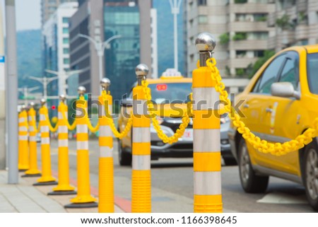 street delimited by yellow flexible pillar, close up traffic pillar