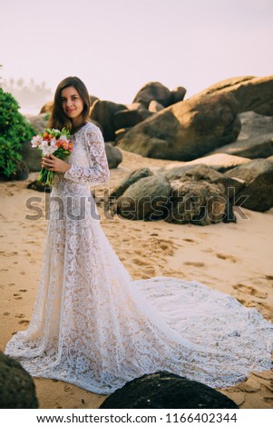 portrait of bride in full growth on tropical beach