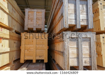 Wooden pallets for shipping stacked in industrial warehouse