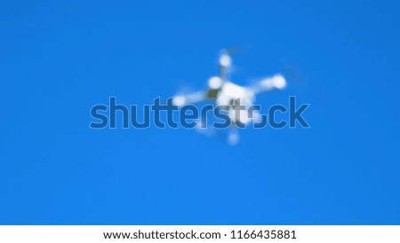 drone photographed deliberately out of focus on a blue sky as a background