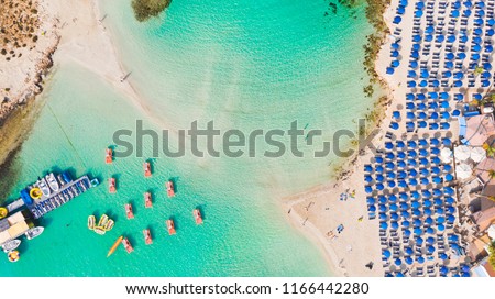 Nissi beach in Ayia Napa, clean aerial photo of famous tourist beach in Cyprus, the place is a known destination on island and is formed from a smaller island just near the main shore Royalty-Free Stock Photo #1166442280