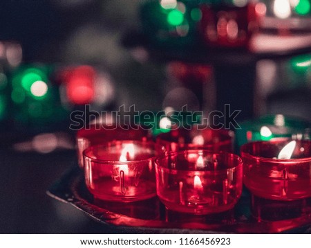 Green and red candles inside a church