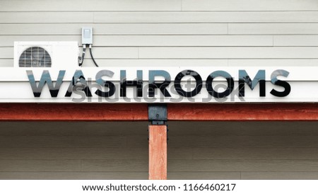 Washrooms Entrance sign on building exterior.