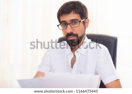 Portrait of a handsome hipster guy working at the office
