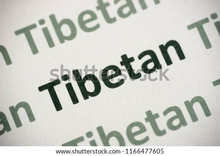 word Tibetan language printed on white paper macro