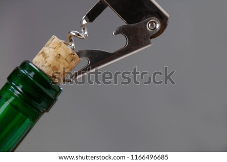 Opening a bottle of wine with a cork