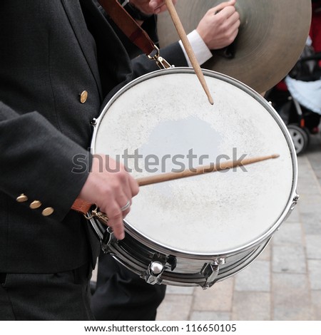 musician of orchestra playing the drum in procession