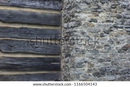 Rustic Stone and wood background of old log cabin divided stone fireplace-grey dark and light textures