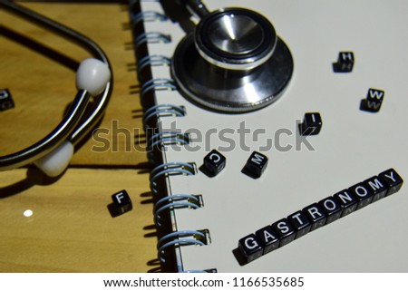concept retro of Gastronomy on wooden cubes with stethoscope, book